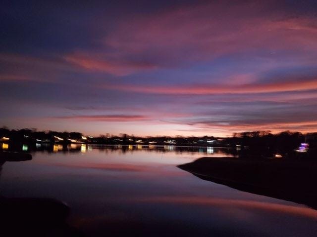 Colorful dusk sky over Lake Conroe at Venice On The Lake